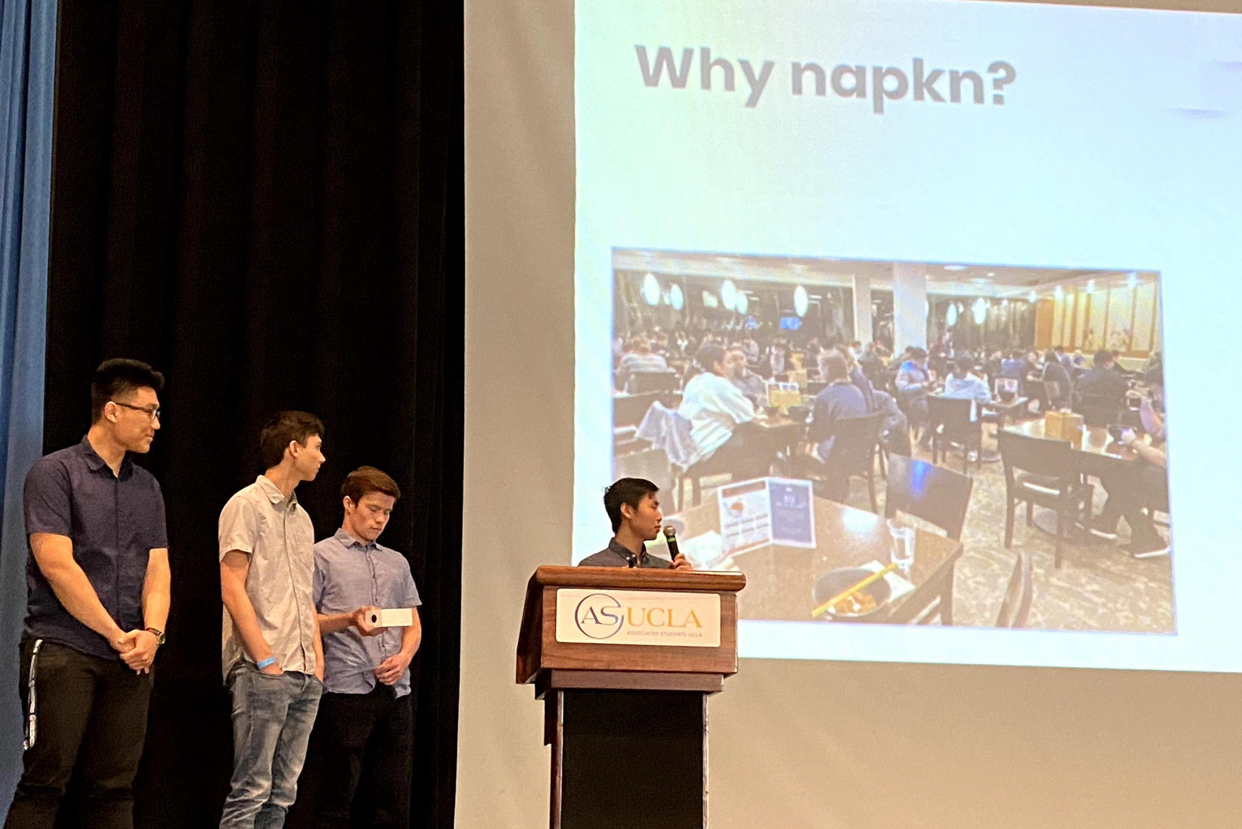 Napkn Team on stage presenting their work to the judges